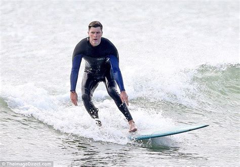 Colin Jost strips off to go surfing after low Emmys viewing figures